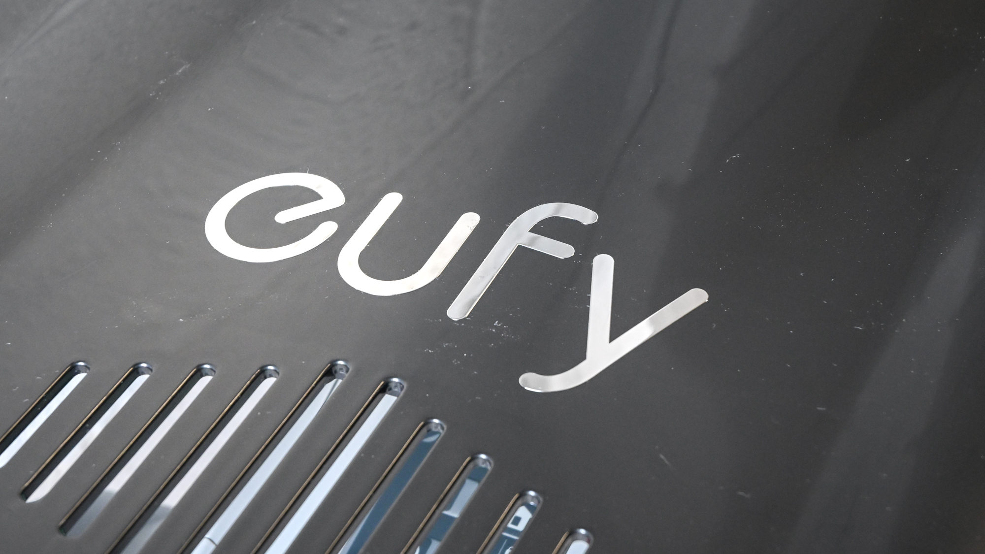 The Eufy E15 robot lawnmower garage, showing the Eufy logo