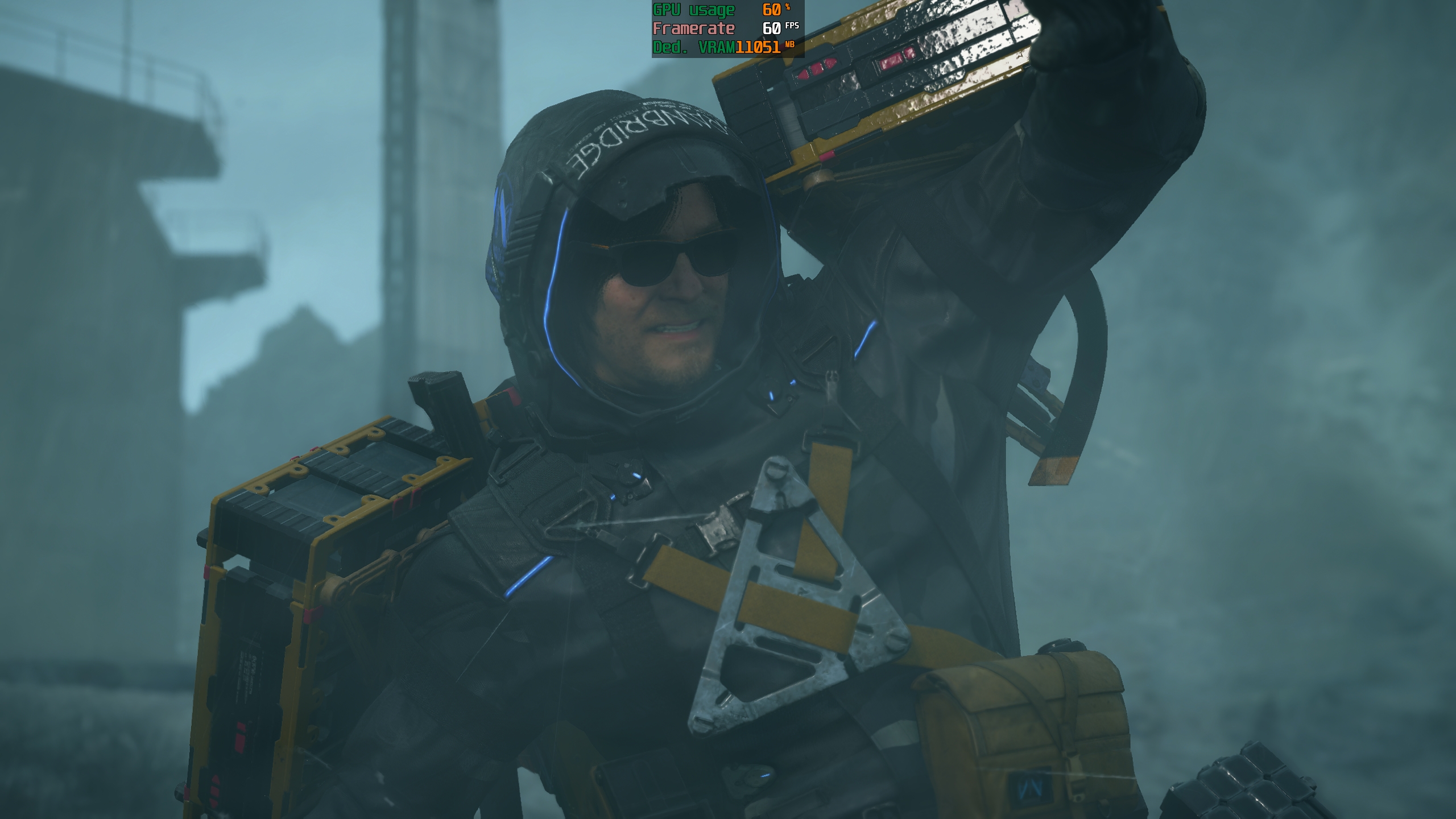 A character in 'Death Stranding' wearing futuristic gear with stats overlay showing 'GPU Usage 60%', 'Framerate 60 FPS', and 'Ded. VRAM 11051 MB'.