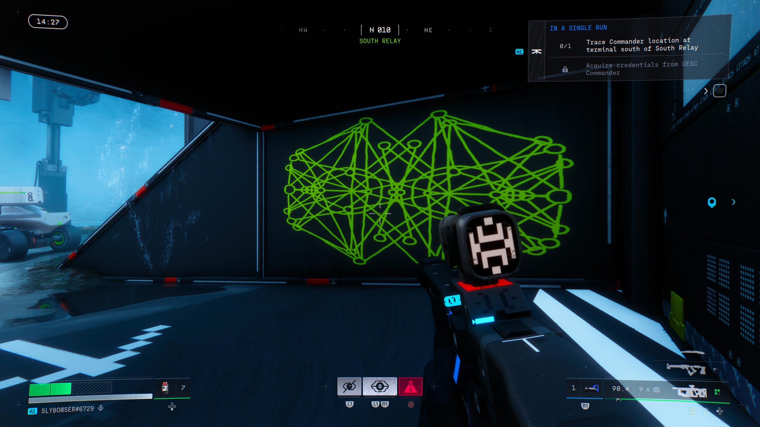 In the game Hyenas, a player character equipped with a futuristic weapon navigates a room featuring a neon green network diagram on the wall, with an objective prompt reading 'Trace Commander location at terminal south of South Relay.'