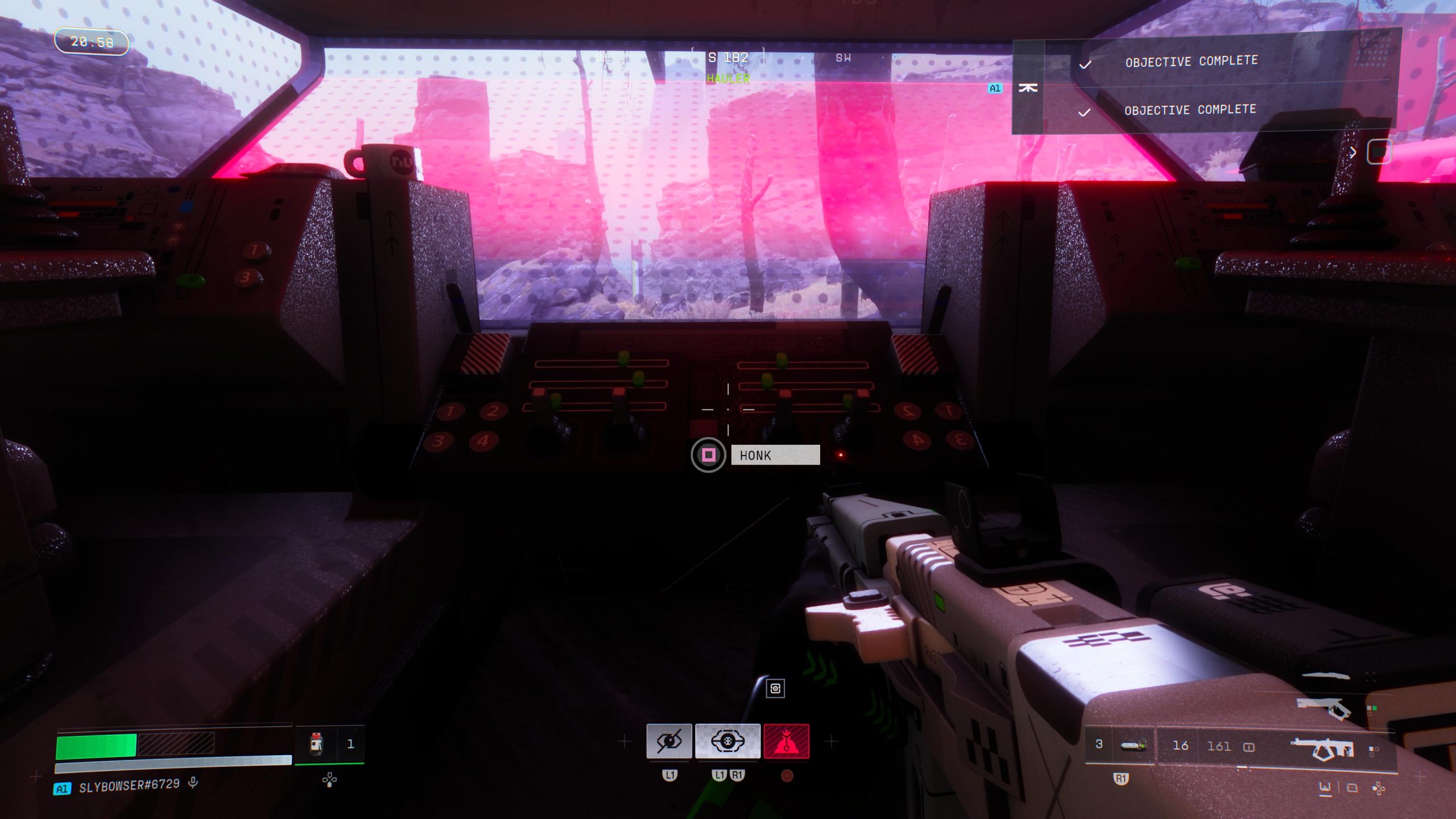 A cockpit view in a video game shows a player holding a futuristic gun with the option to 'Honk' and on-screen text displaying 'OBJECTIVE COMPLETE'.