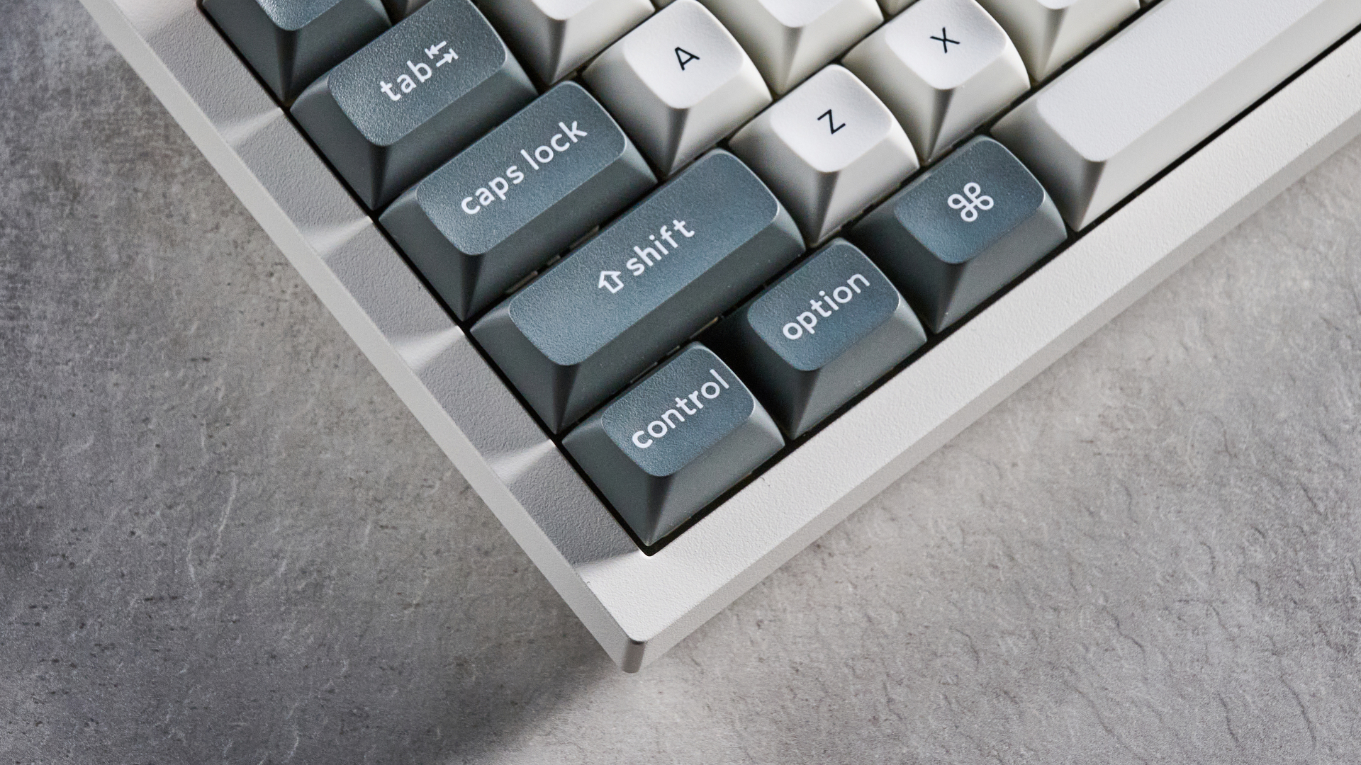 Keychron Q3 Ultra 8K photographed on a grey table in front of a blue background